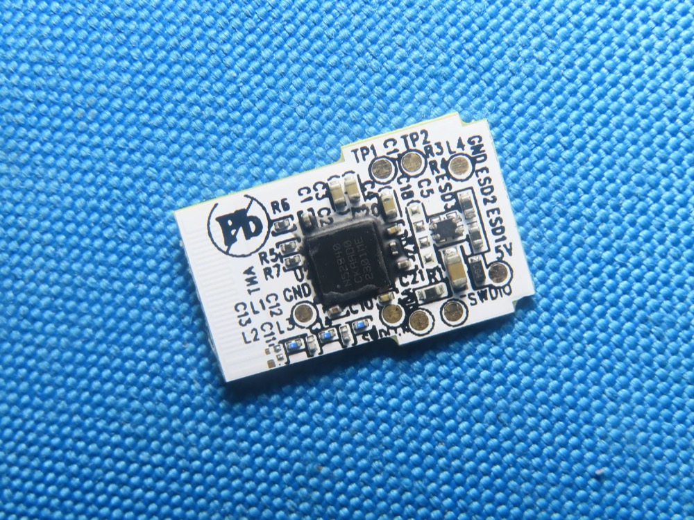 Dongle back: nRF52840 with labeled SWDIO/TP1/TP2 test points (FCC exhibit)