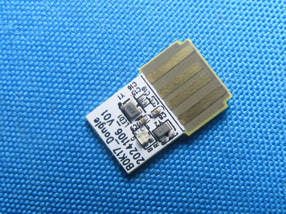 Dongle front: USB-A plug, BOK17_Dongle 20241106 V01 silkscreen, LED (FCC exhibit)